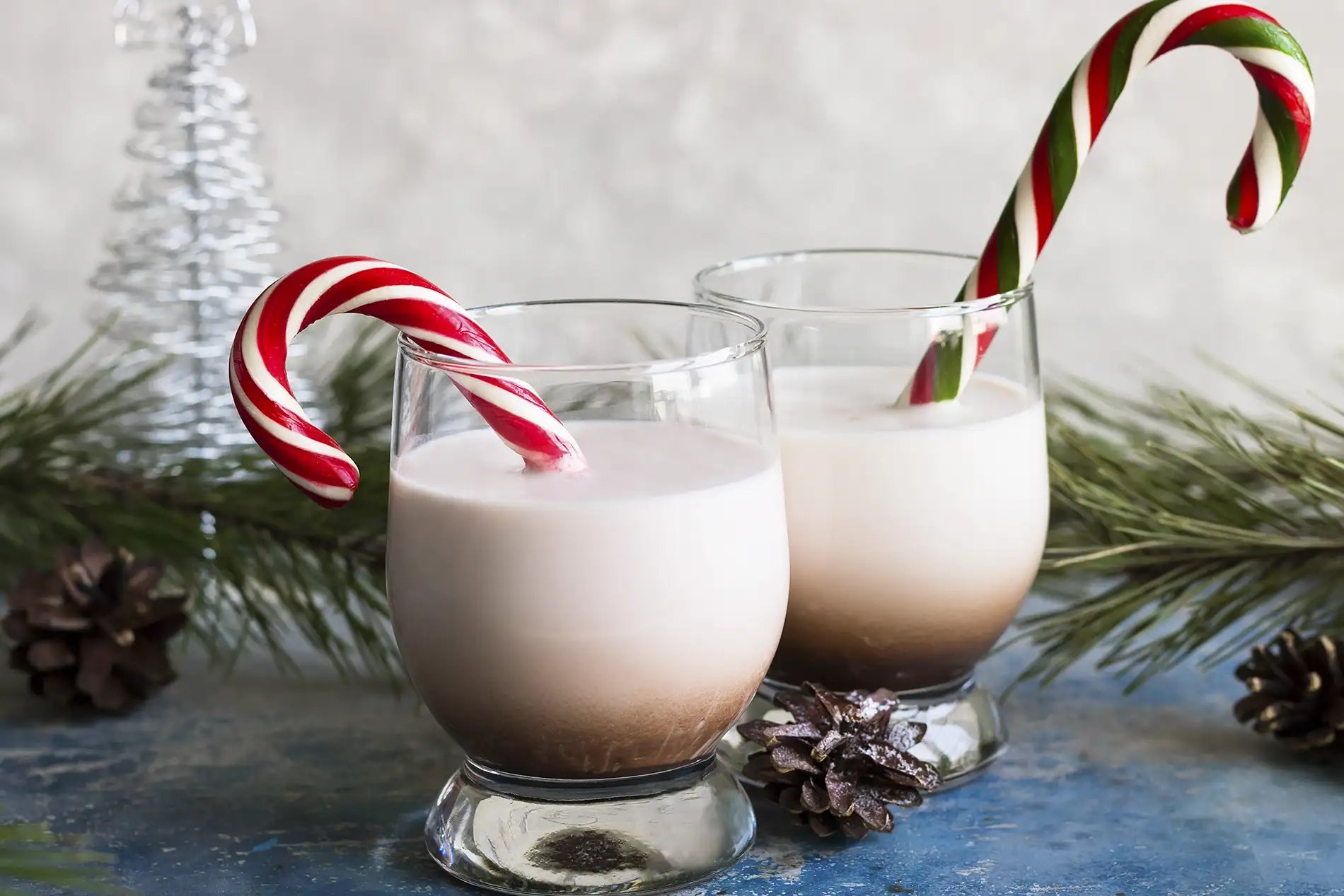 A Bailey's eggnog cocktail with peppermint candy cane garnish