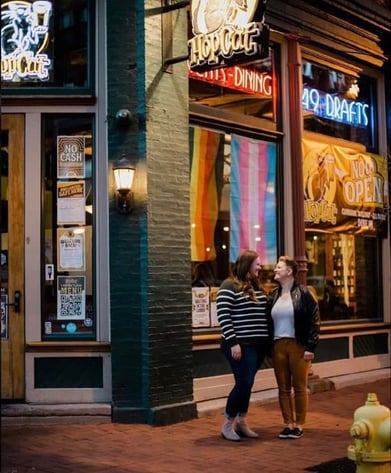 Couple standing outside of HopCat at night