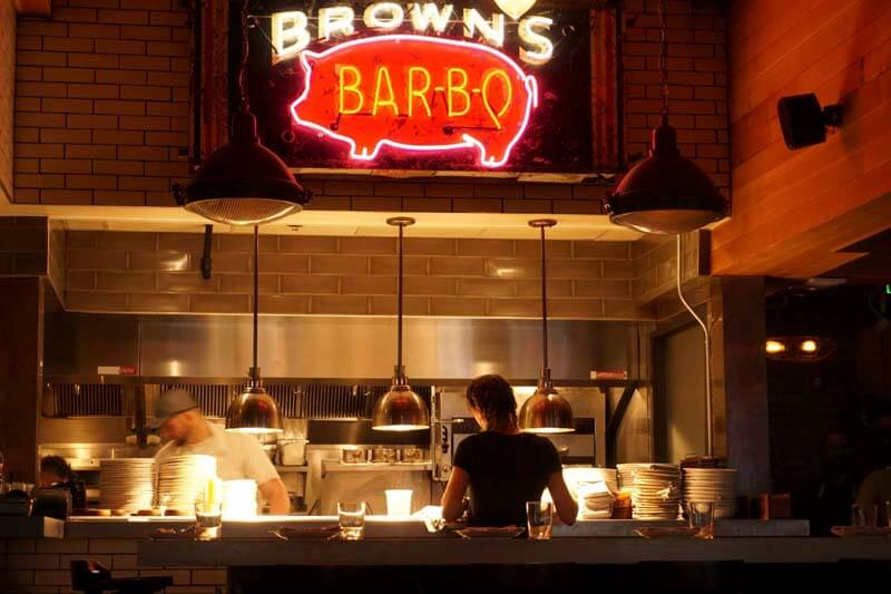 A photo of a busy bar-b-q food counter