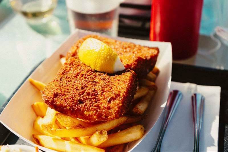 Fried fish and chips or french fries served at a bar