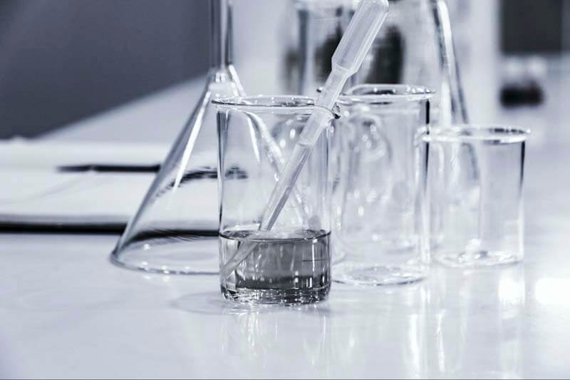 Glass beakers, eye droppers, and other chemistry tools in a clean room environment