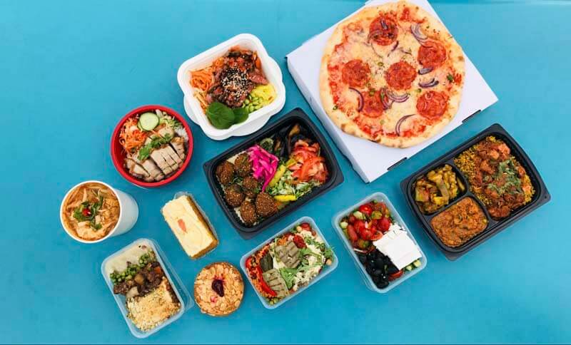 An overhead photo of various food items and meals that are perfect option for food delivery services and apps