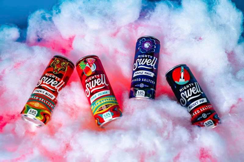 A promotional photo of a vareity of Mighty Swell spiked seltzer cans