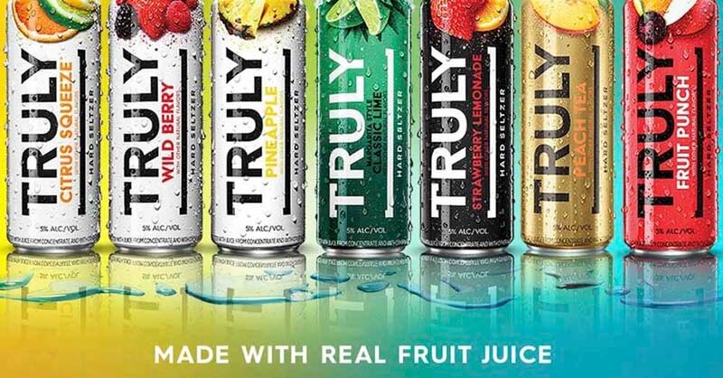 Promotional photo for Truly Hard Seltzers advertising that they are now made with real fruit juice