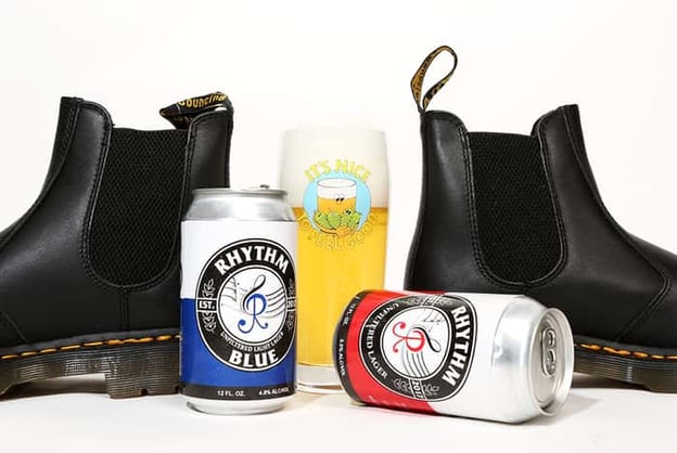 Rhythm Blue cans with Dr. Martens boots in background