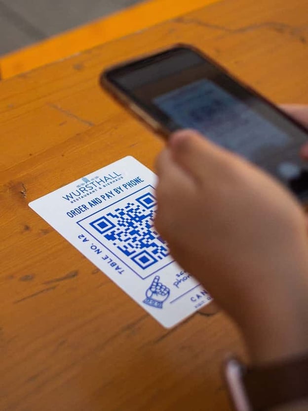 Visitor scanning QR code to pay by phone