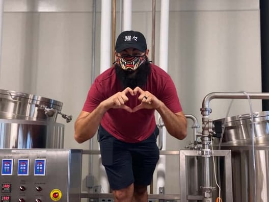 Shojo Beer Company founder making a heart with his hands
