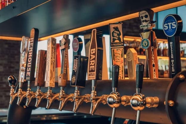 Row of beer taps at bar in Eureka! Restaurant