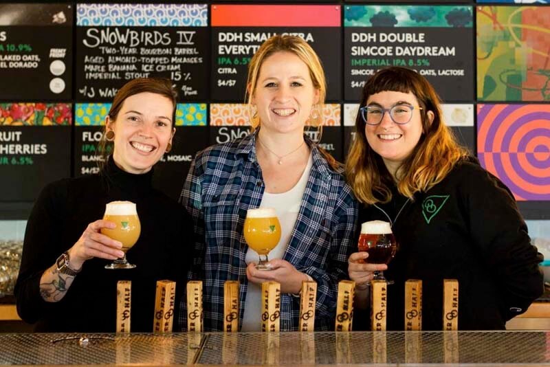 A smiling trio of bartenders from Other Half, a D.C. taproom