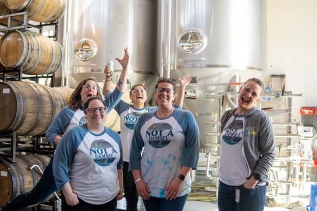 Staff posing at brewery inside Two Roads Brewing Company