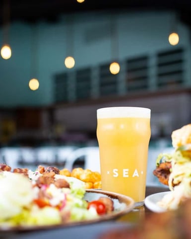 Beer and food on an outdoor table at Humble Sea Brewing Company